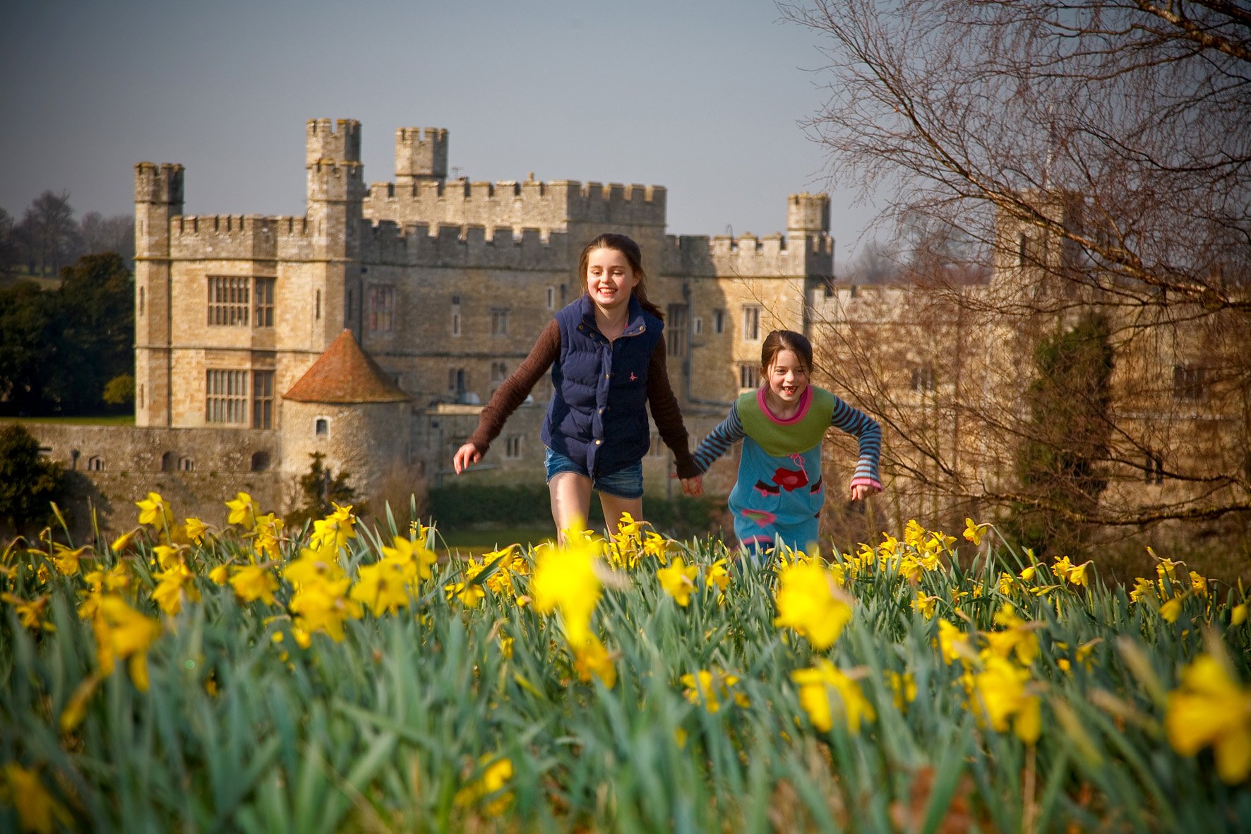 children running in front of castle