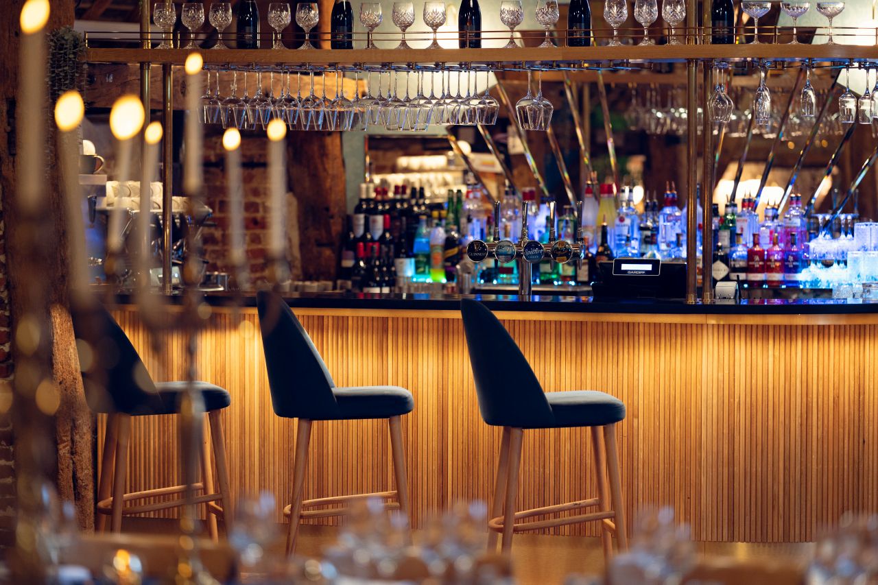 An image of the Castle View Restaurant bar with warm lighting and a stocked bar